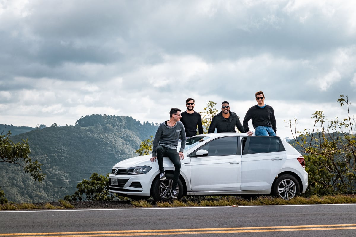 Cheerful diverse friends having road trip together